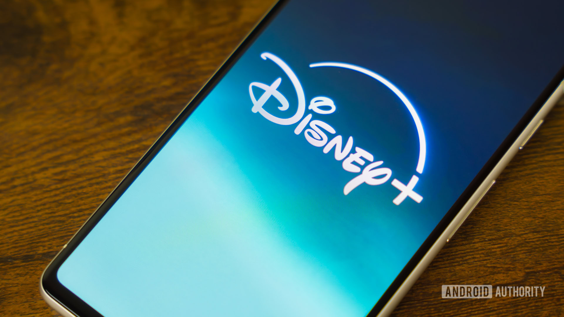 Disney Plus logo on smartphone laying on side table stock photo (4) Disney Plus logo on smartphone laying on side table stock photo (4)