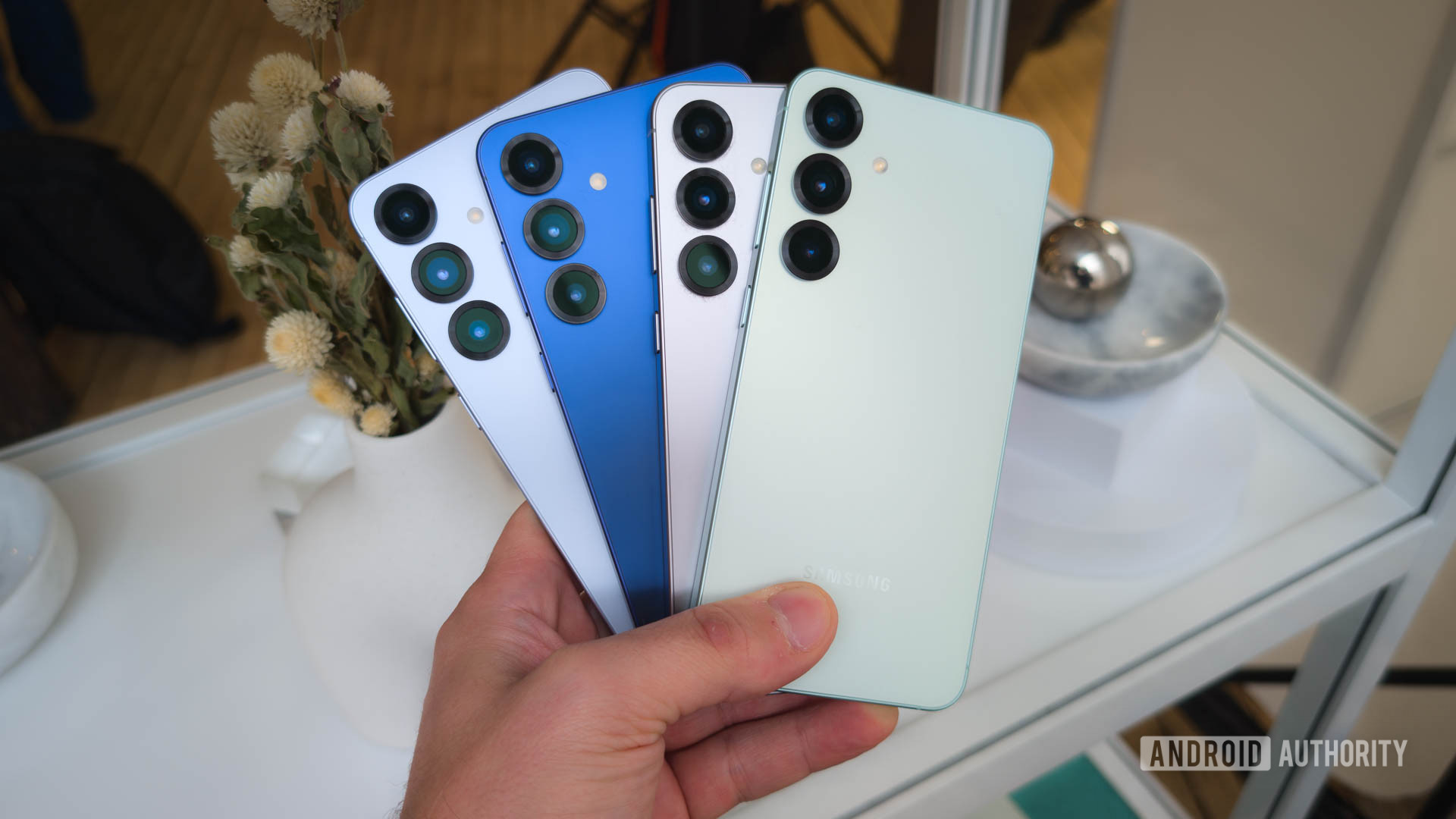 Samsung Galaxy S25 Plus in all four colors fanned in hand Samsung Galaxy S25 Plus in all four colors fanned in hand