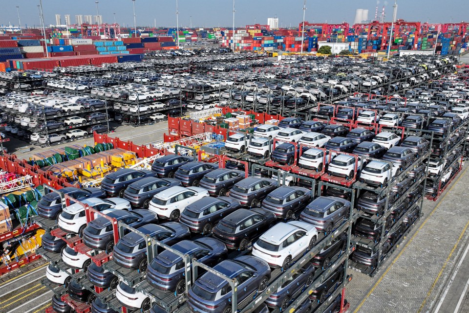 Aerial view of BYD electric cars at a port awaiting export.