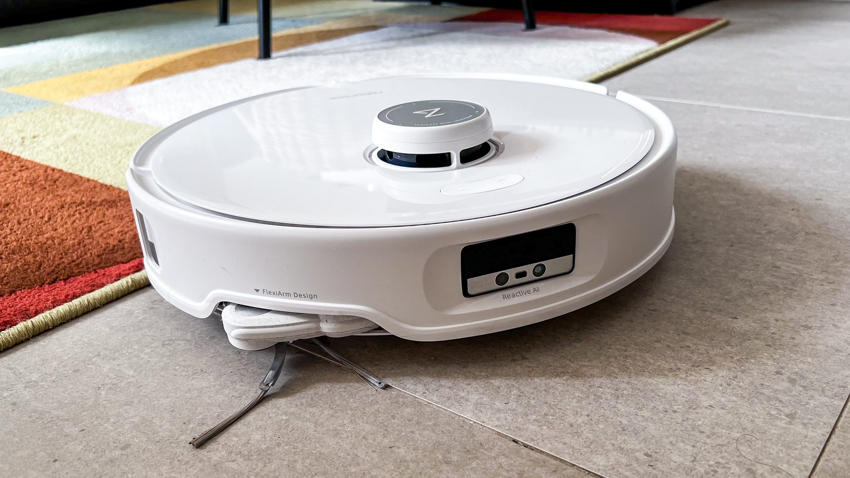 Roborock Qrevo Edge robot moving from a rug to hard floor