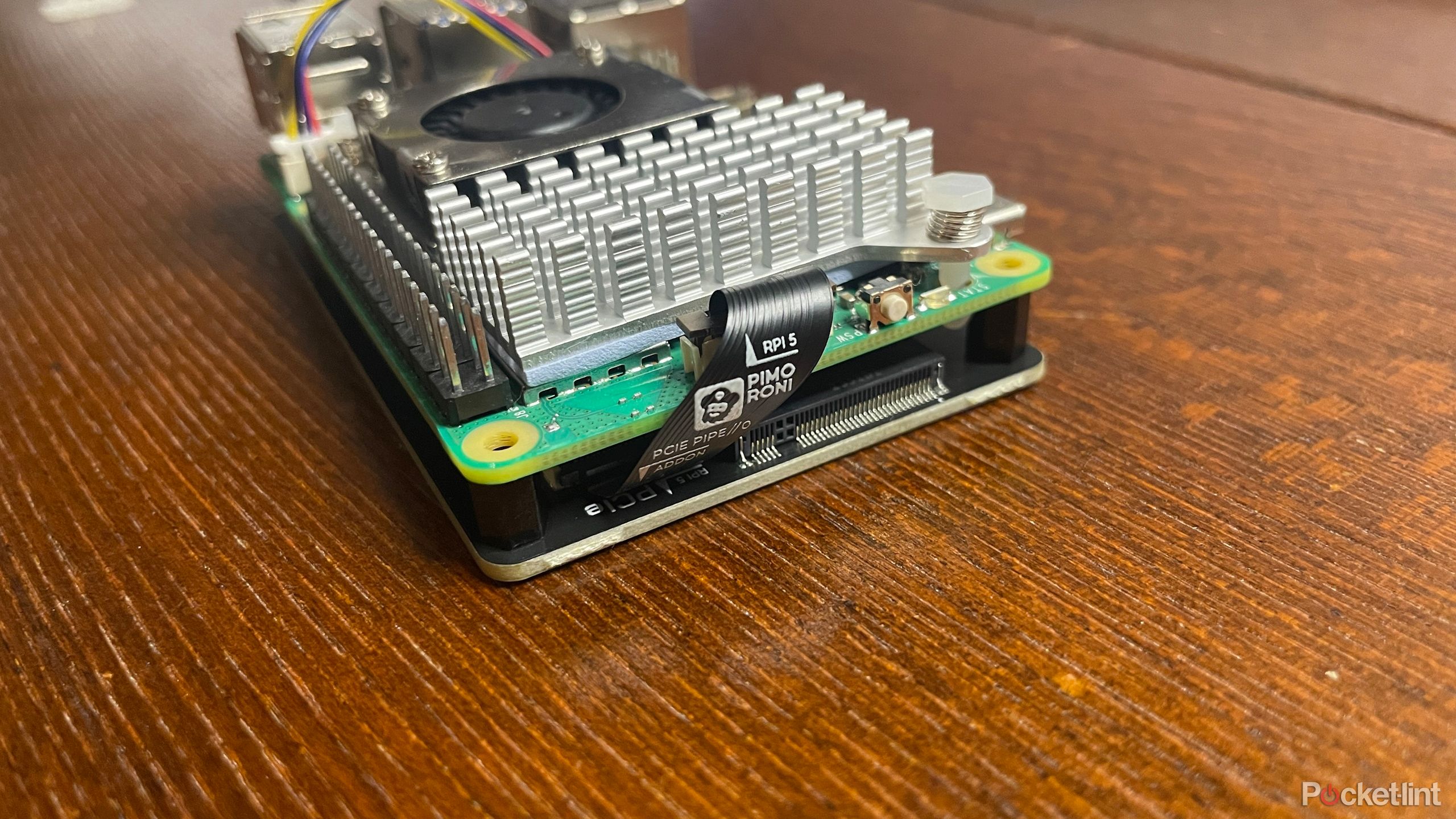 Close up on ribbon cable attached to Pimoroni NVMe Base and Rapsberry Pi 5