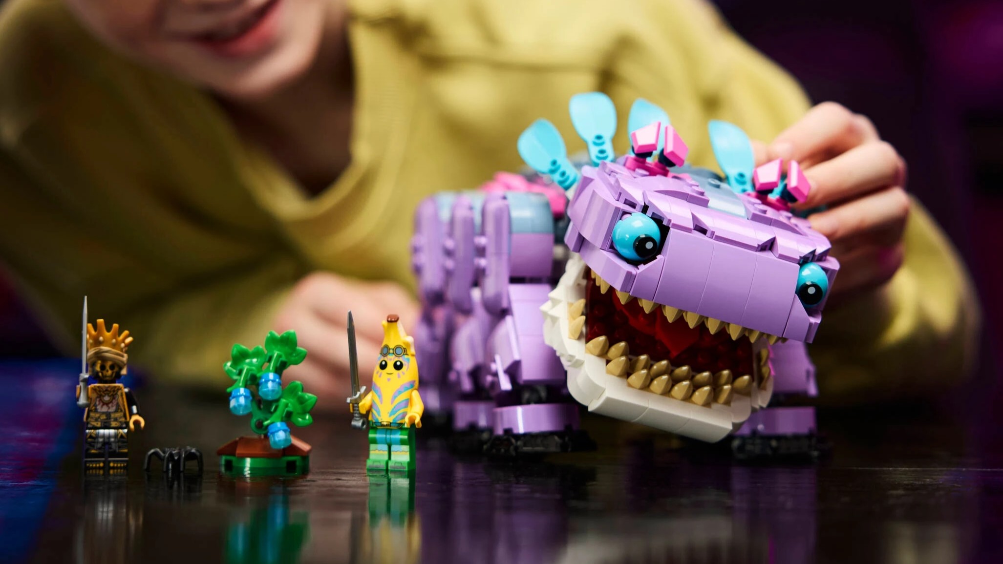 A kid playing with a Lego Klombo
