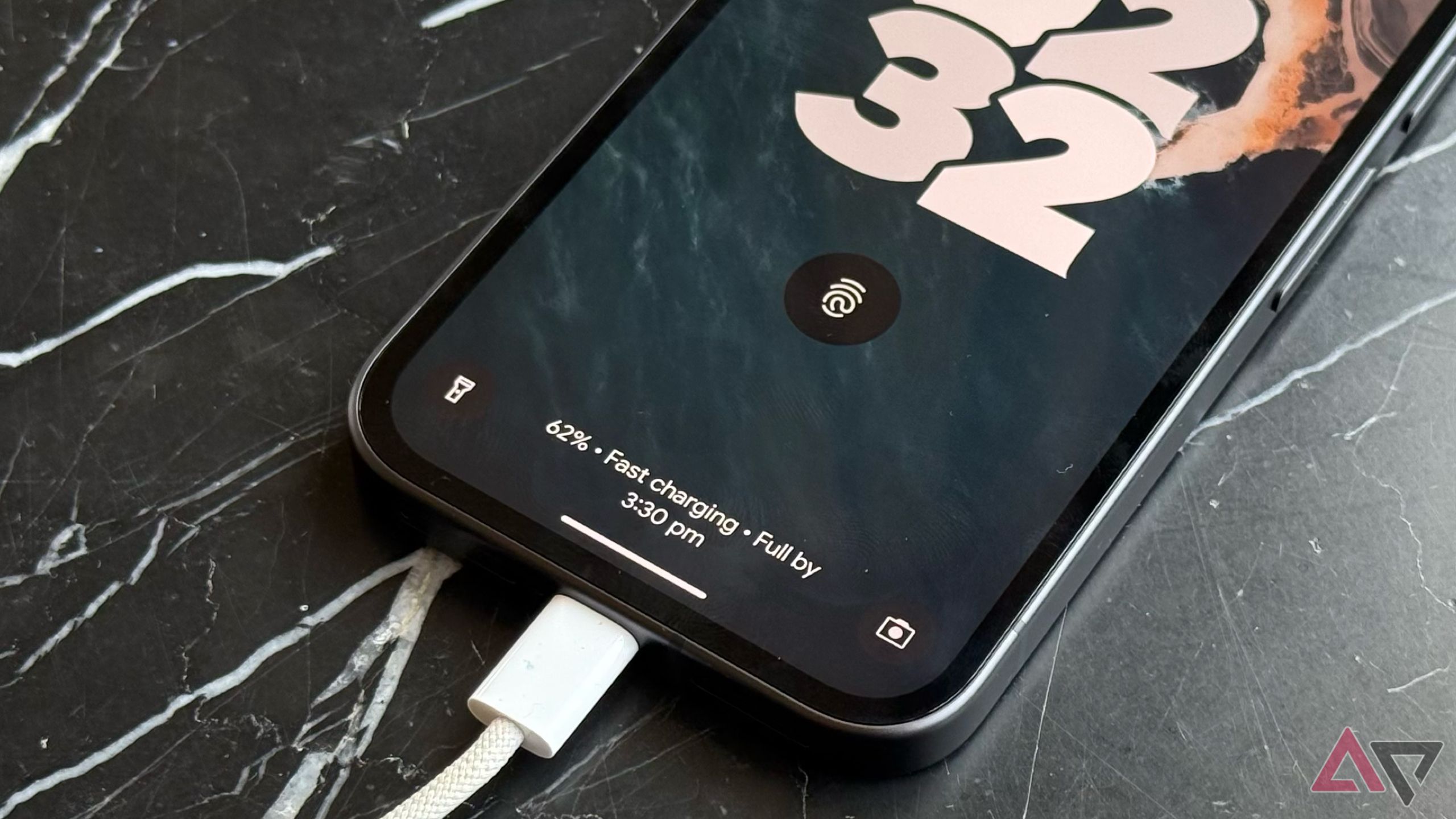 Android smartphone Google Pixel 9a resting on a table while charging
