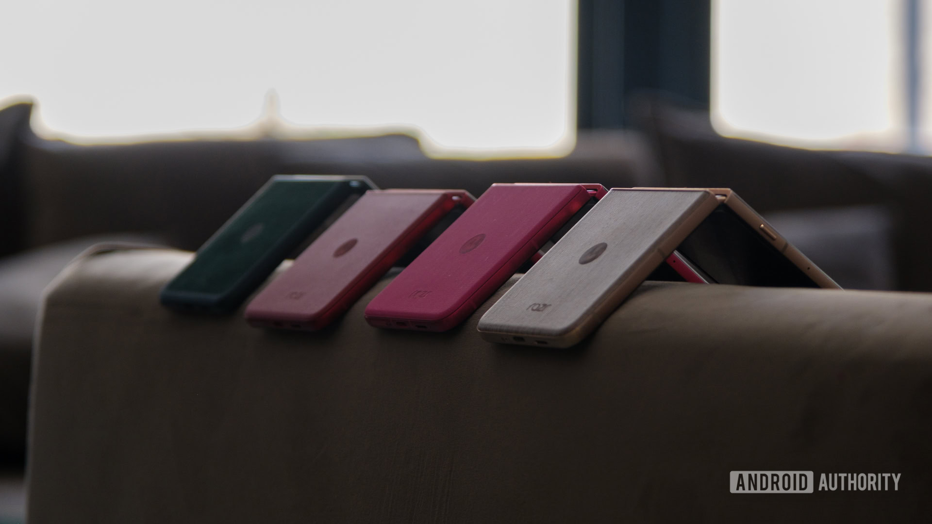 Motorola Razr 2025 series colors on the arm of a couch Motorola Razr 2025 series colors on the arm of a couch