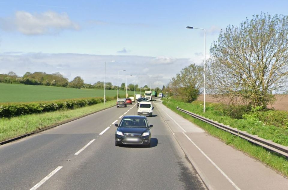 Cars driving on a rural road.