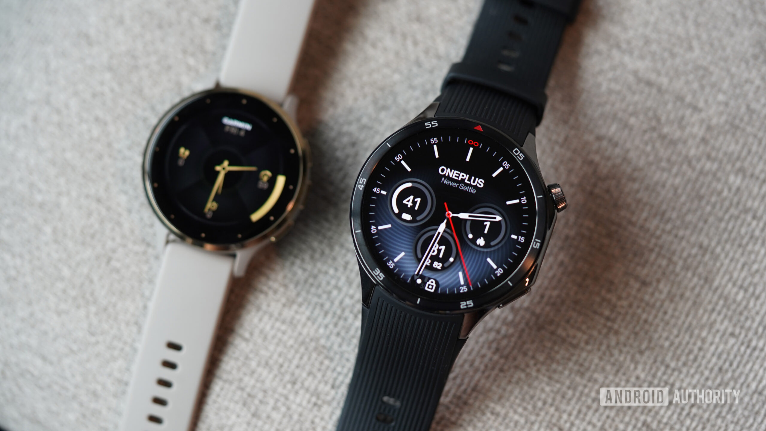 A OnePlus Watch 3 rests in front of a Garmin Venu 3.