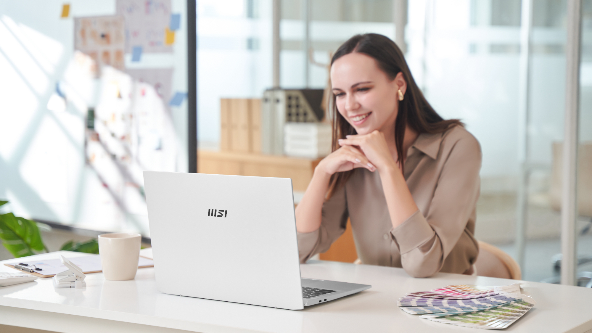 Photo of a woman using an MSI Prestige A16 AI+ laptop