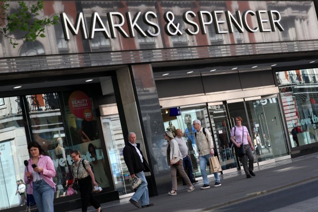 epa12062153 Pedestrians walk outside a Marks & Spencer (M&S) retail store in London, Britain, 29 April 2025. On 25 April the retail store reported a cyber incident which suspended their online market place system, prompting the company to announce the temporary halt to online shopping until further notice. EPA/ANDY RAIN