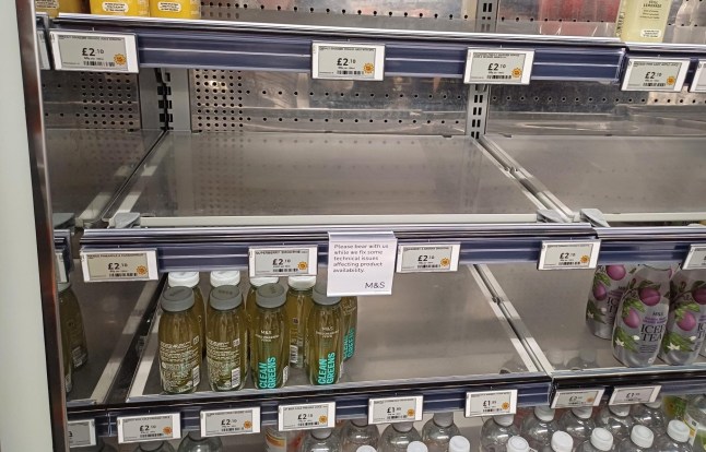 A view of empty shelves inside a Marks & Spencer shop.