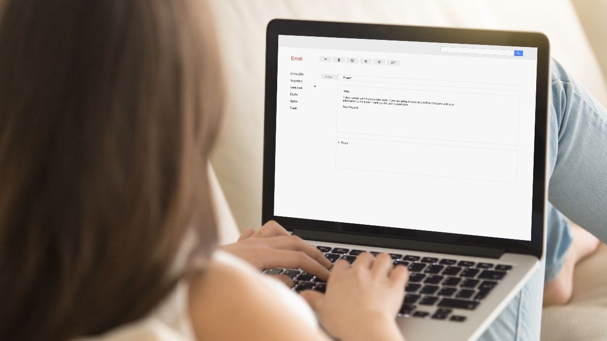 Woman typing an email on a laptop