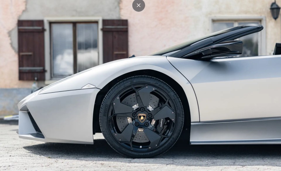 Close-up of a silver Lamborghini Reventón Roadster's front wheel and side.