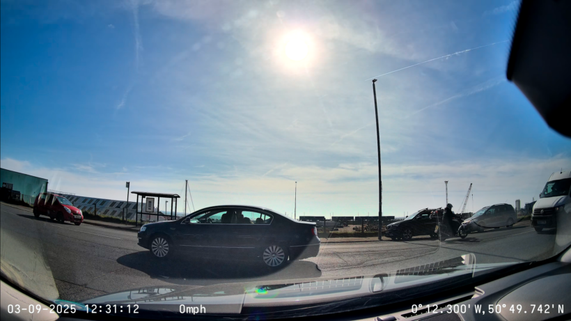 Front view directly into sun. Shaded details in a passing car are still captured faithfully
