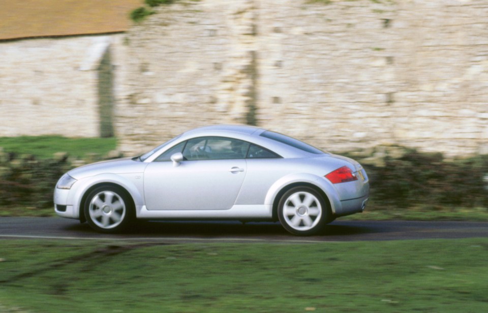 Silver Audi TT Quattro driving on a road.