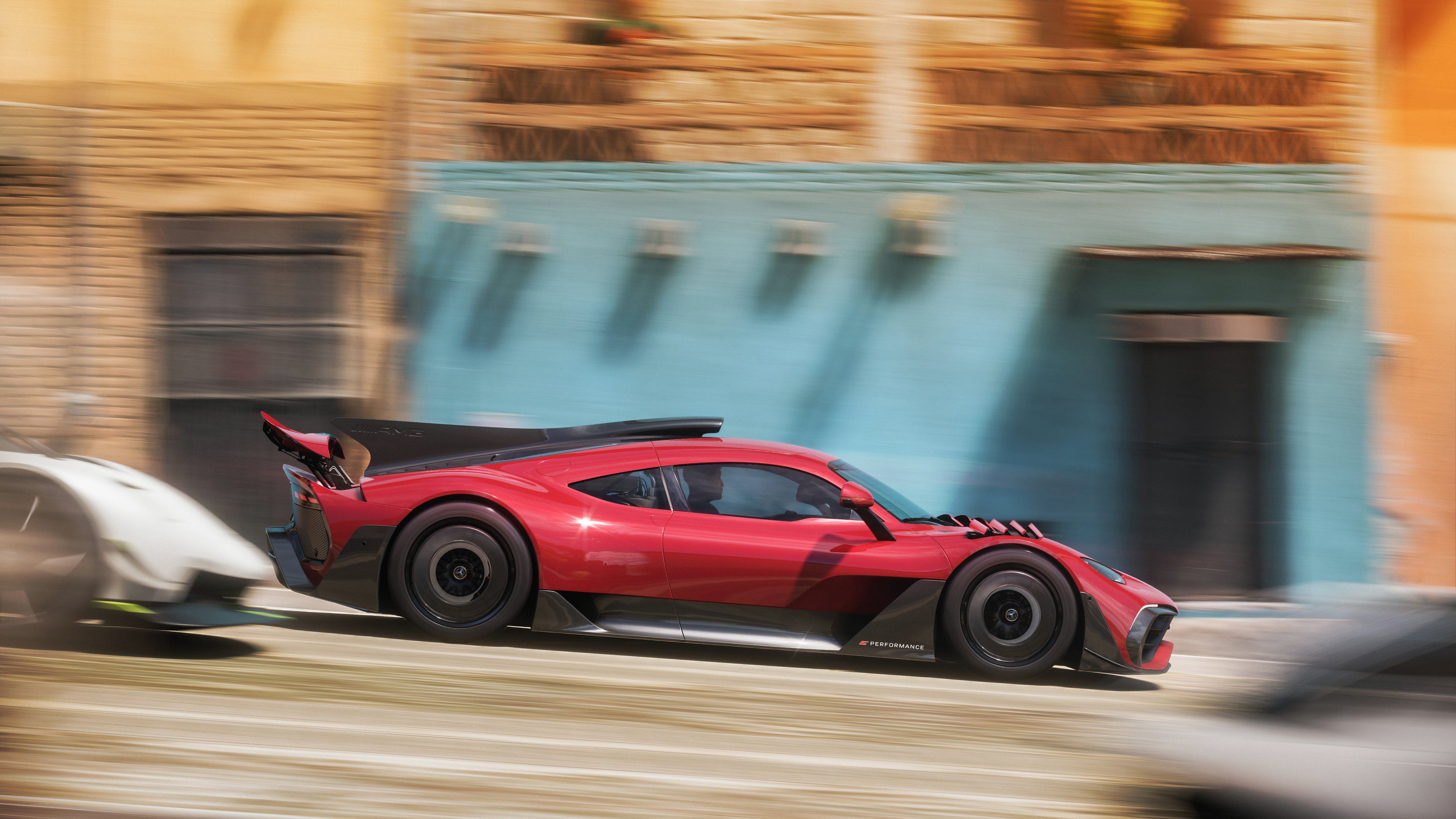 A red car zooming by other competitors in Forza Horizon 5.