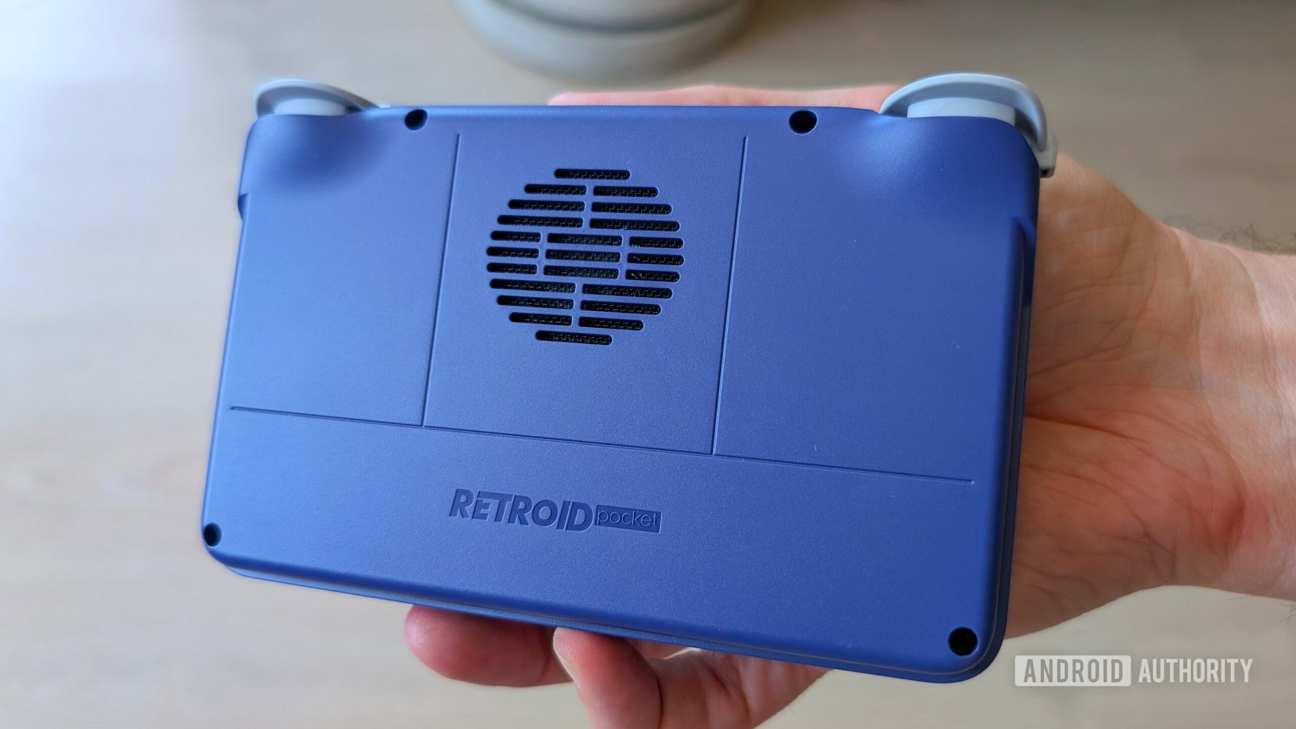 Retroid Pocket Flip 2 in hands back