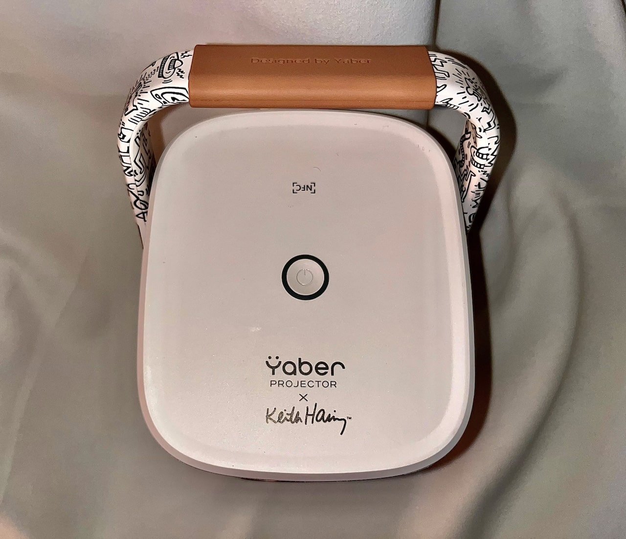 Top view of projector showing power button and Yaber projector text