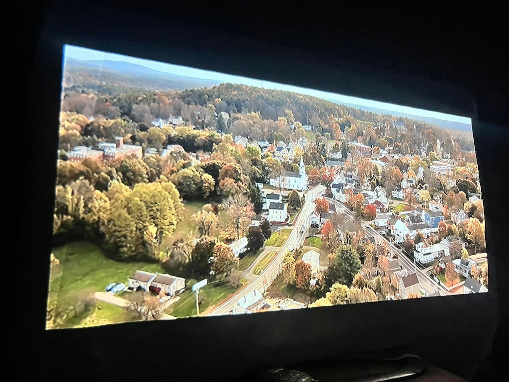 Wide shot of town projected on white sheet