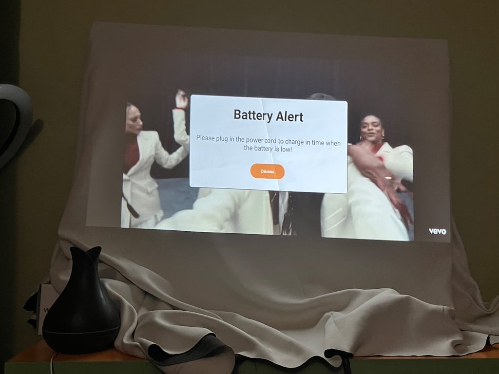 Projected image on white sheet displaying battery warning