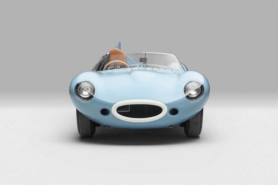 Front view of a light blue Jaguar D-Type sports car.