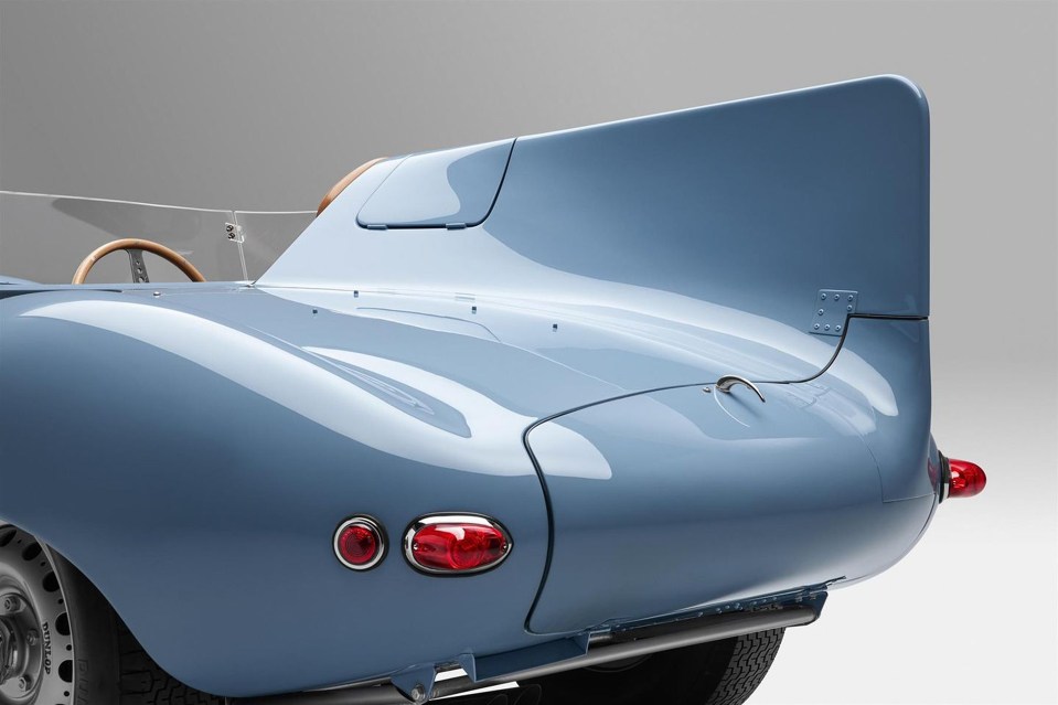 Rear view of a light blue Jaguar D-Type sports car.