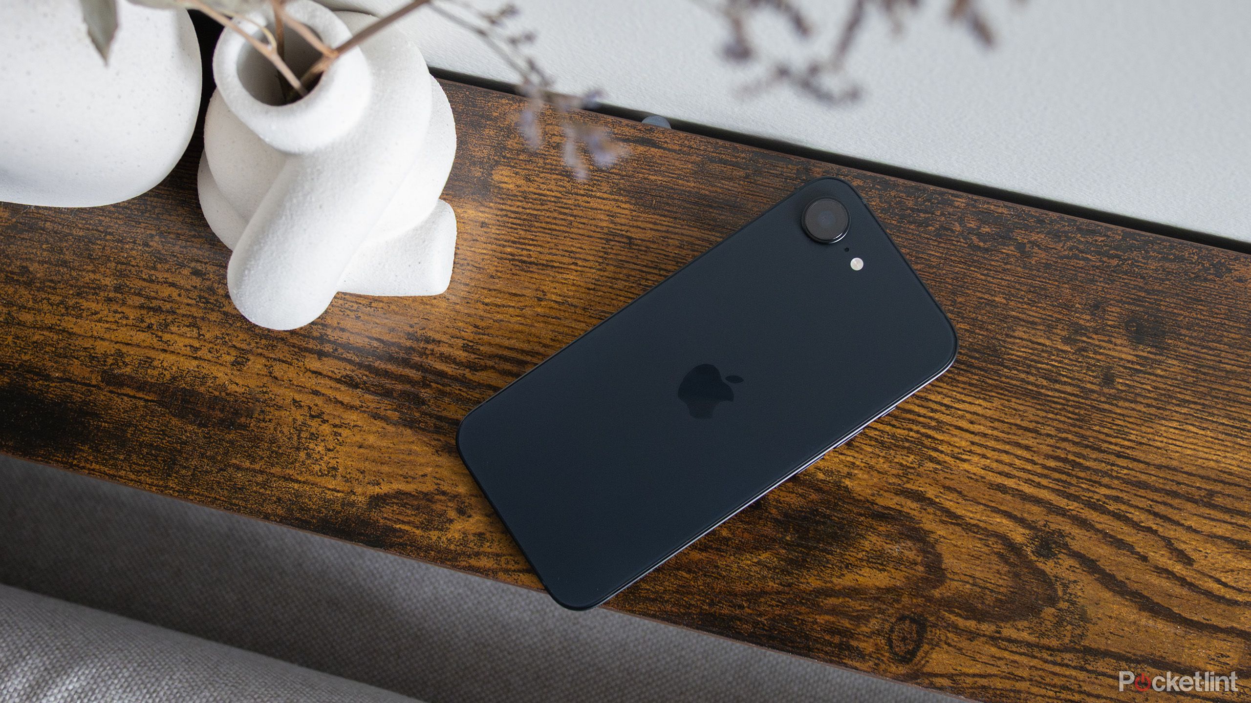 iPhone 16e on a table.