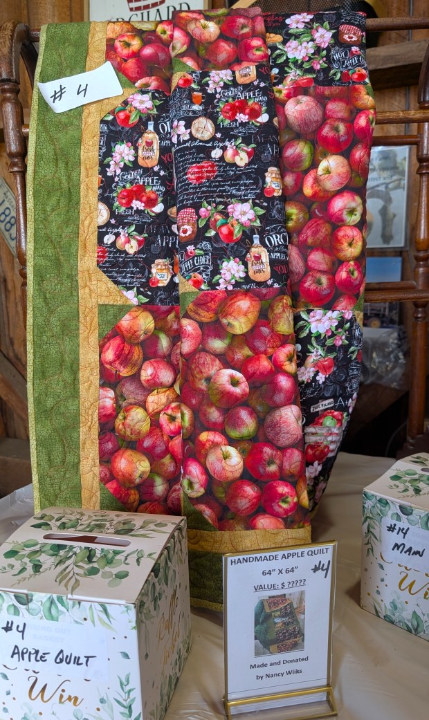 A beautiful apple themed quilt made and donated by Friends of Sholan Farms volunteer Nancy Wiiks was one of the raffle items up for grabs at the 24th annual Apple Blossom Festival on May 17 at Sholan Farms in Leominster. (DANIELLE RAY/SENTINEL & ENTERPRISE)