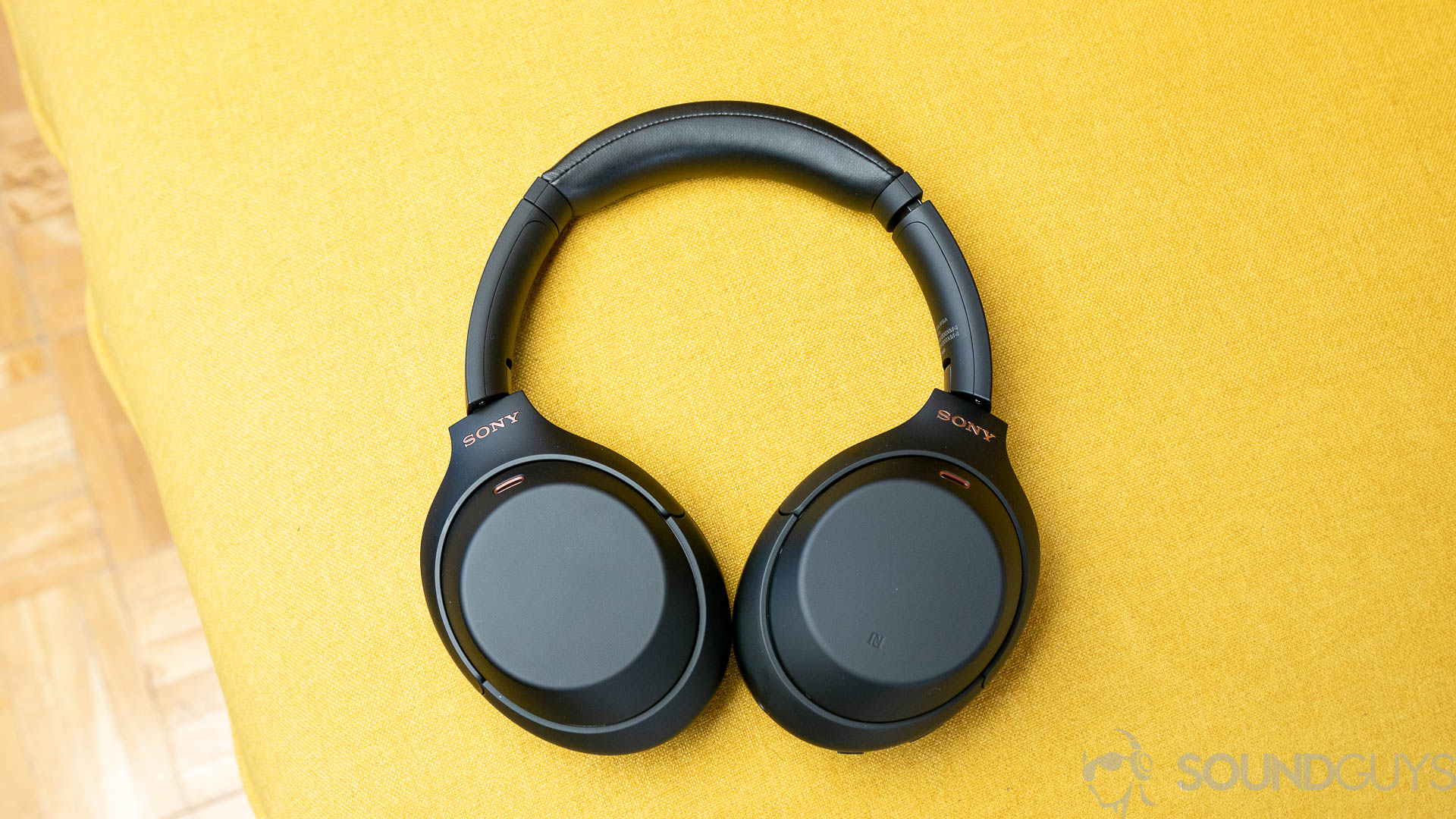 Sony WH 1000XM4 2 of 10 The Sony WH-1000XM4 headphones on a yellow couch.