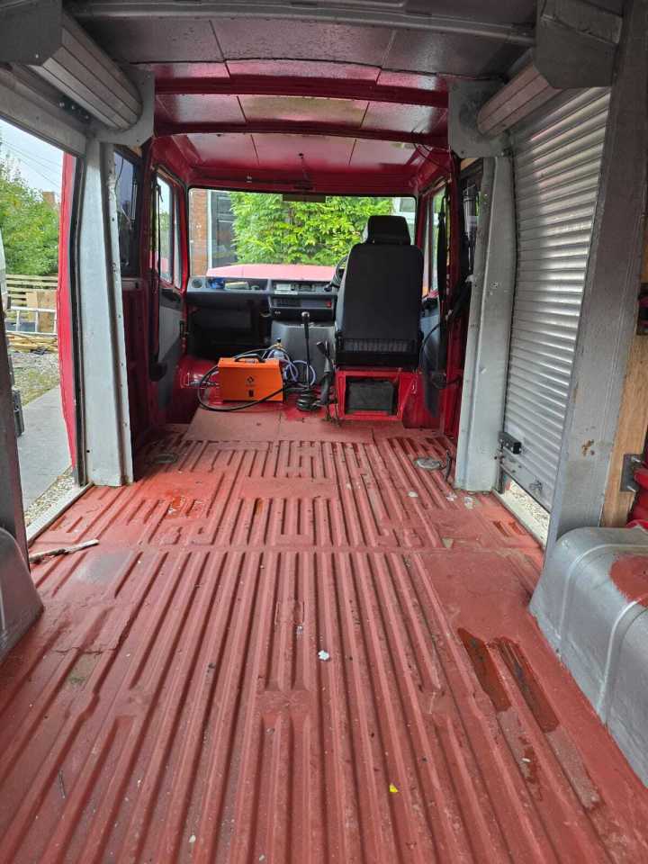 Interior of a red campervan conversion project.