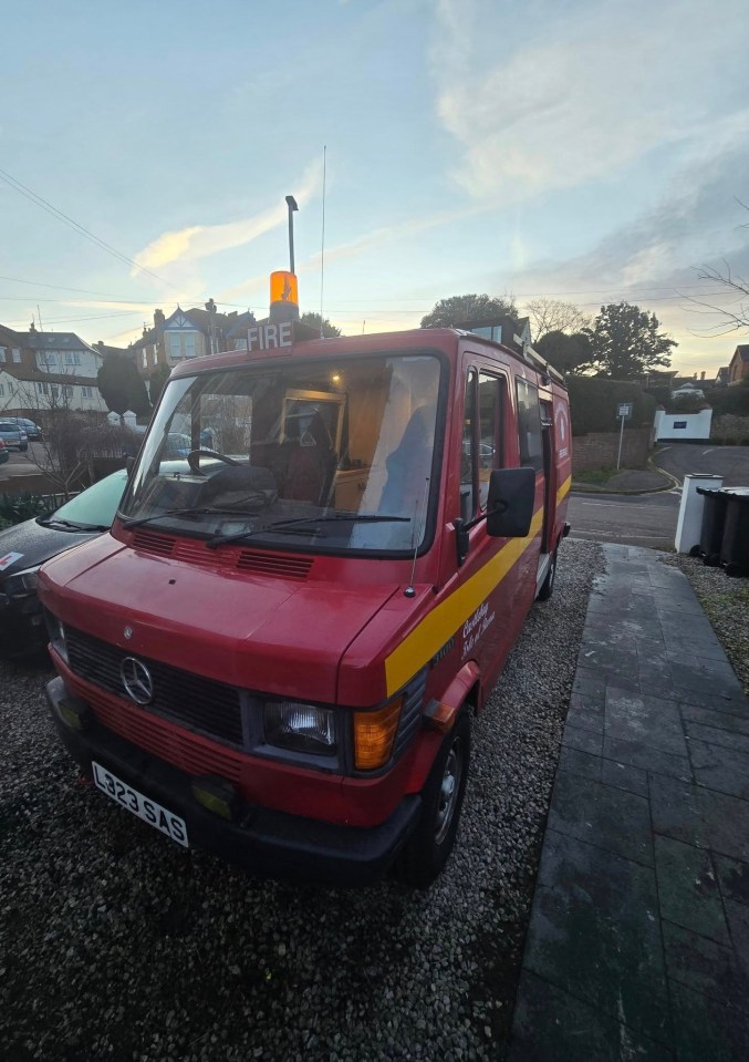 A red retired fire engine converted into a campervan.