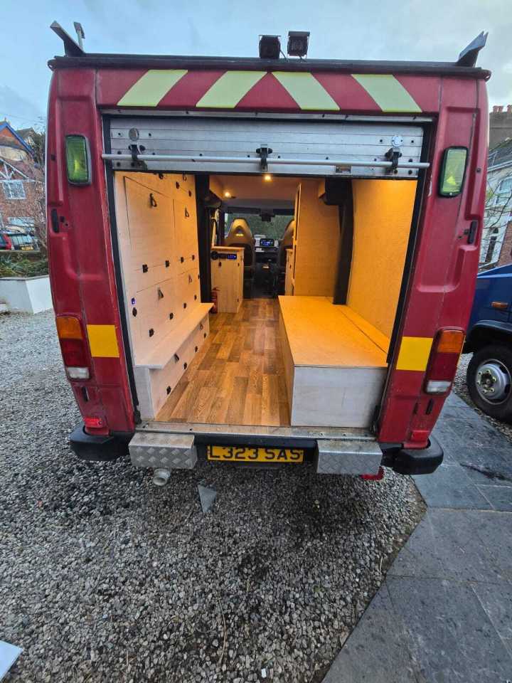 Converted firetruck campervan interior.
