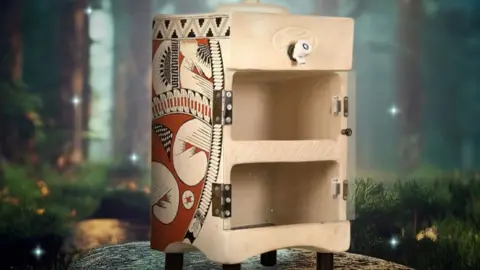 MittiCool A MittiCool clay fridge - not much bigger than a microwave oven, with decorative patterns on the side.