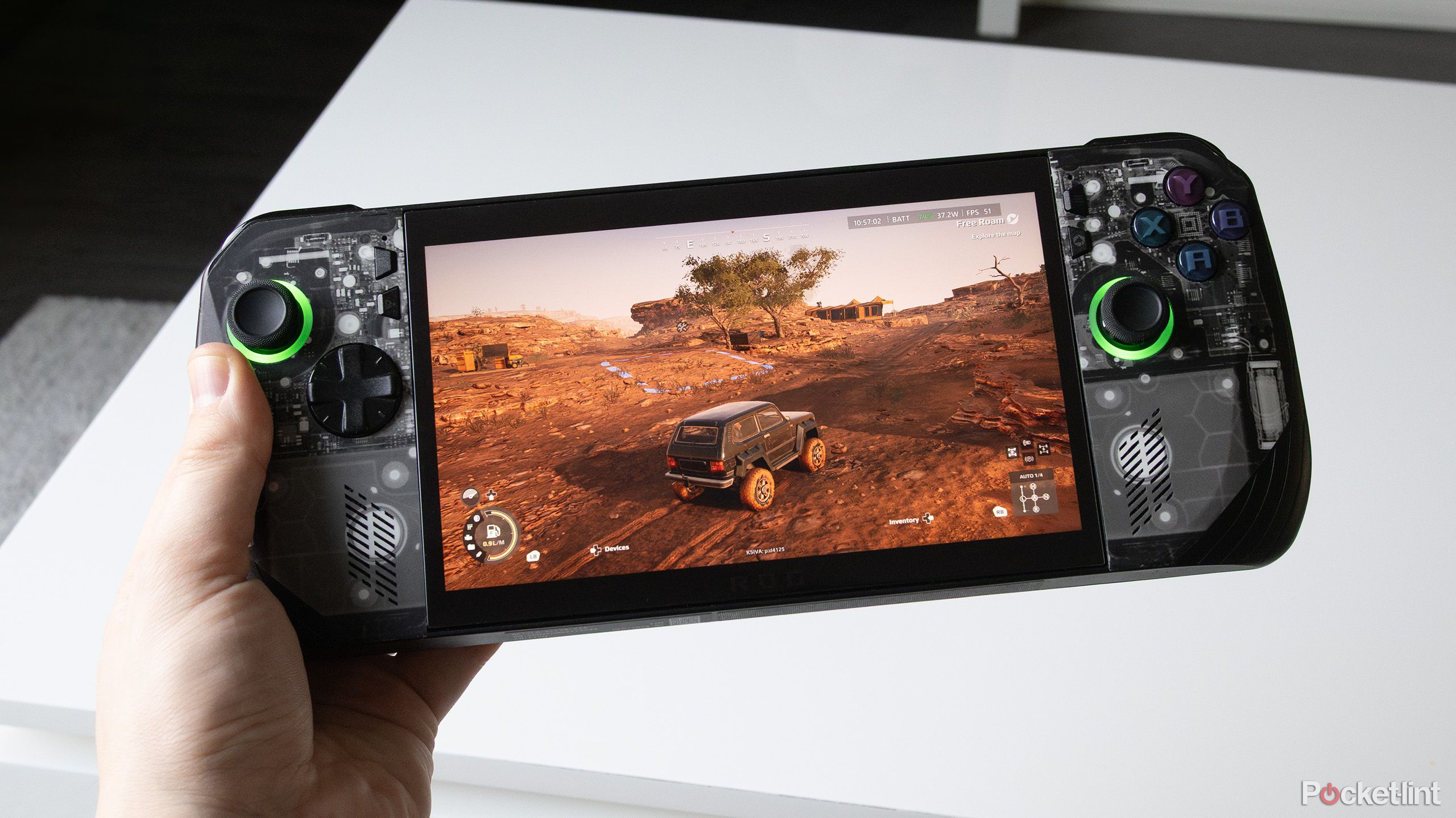 ROG Ally X playing a game with a car on a dirt road.