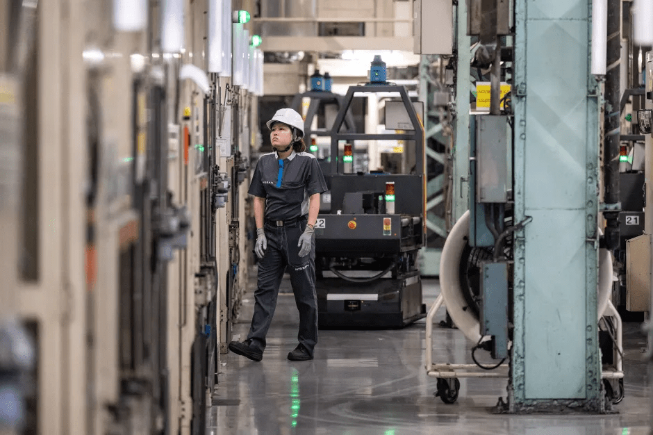 Factory worker standing in an industrial facility.