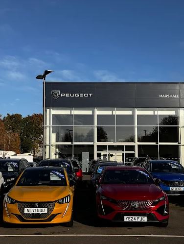 Marshall Peugeot Gatwick dealership with cars on display.