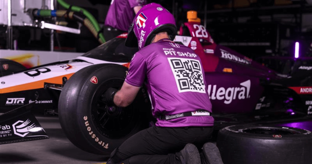 Andretti Global team members in QR code jumpsuits