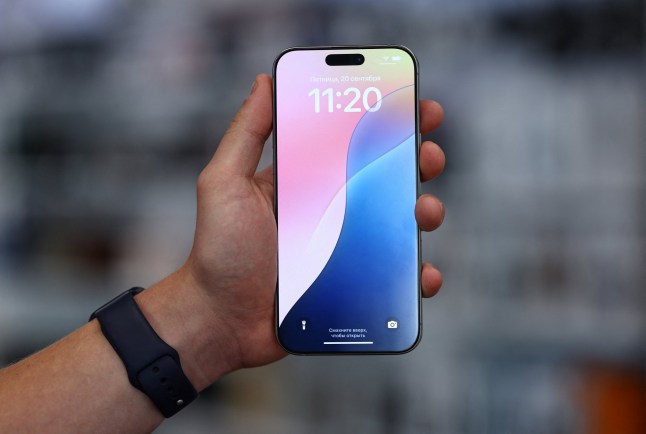 A man holds an Apple iPhone 16 Pro Max ahead of the launch of sales of the new iPhone 16 series smartphones in a store in Moscow, Russia September 20, 2024. REUTERS/Evgenia Novozhenina