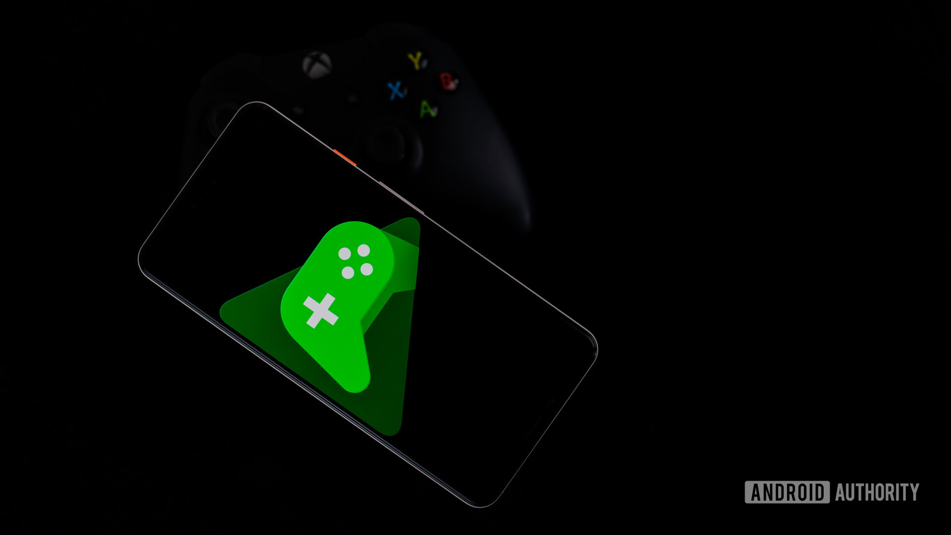 Google Play Games on smartphone with controller stock photo 4 Google Play Games on smartphone with controller stock photo 4