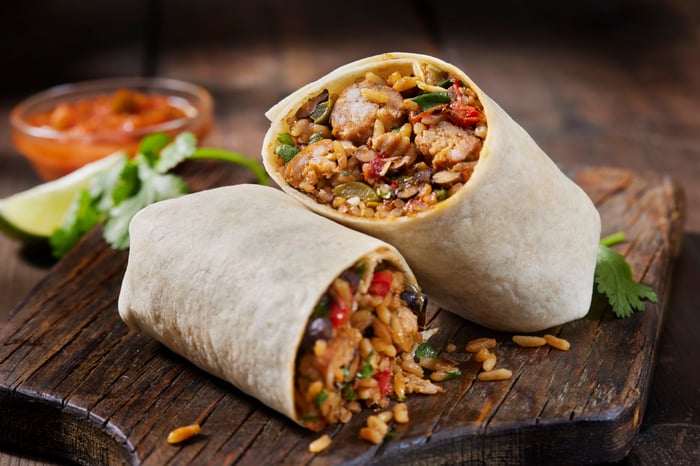 Burritos on a table.