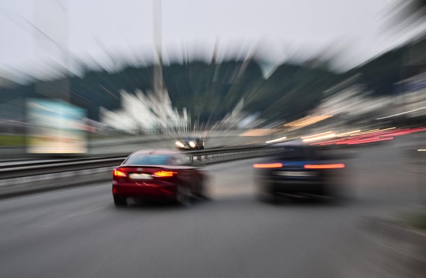 Evening city street racing cars blurred motion 