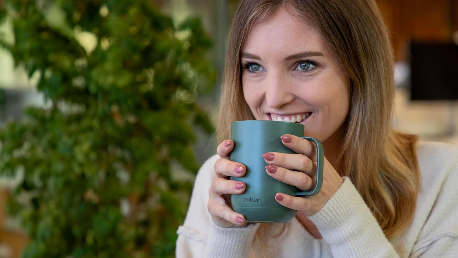Woman drinking from green Ember Mug 2 Woman drinking from green Ember Mug 2