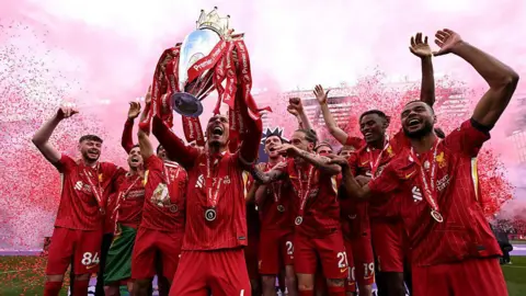 Getty Images Liverpool football players celebrate winning the English Premier League title