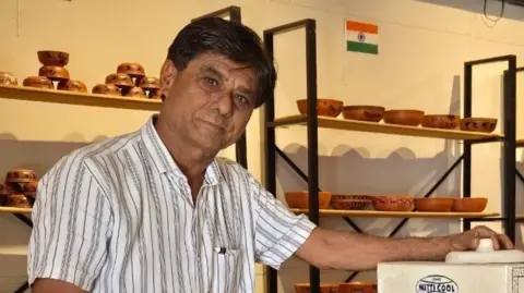 Mansukh Prajapati Mansukh Prajapati with clay pottery in the background