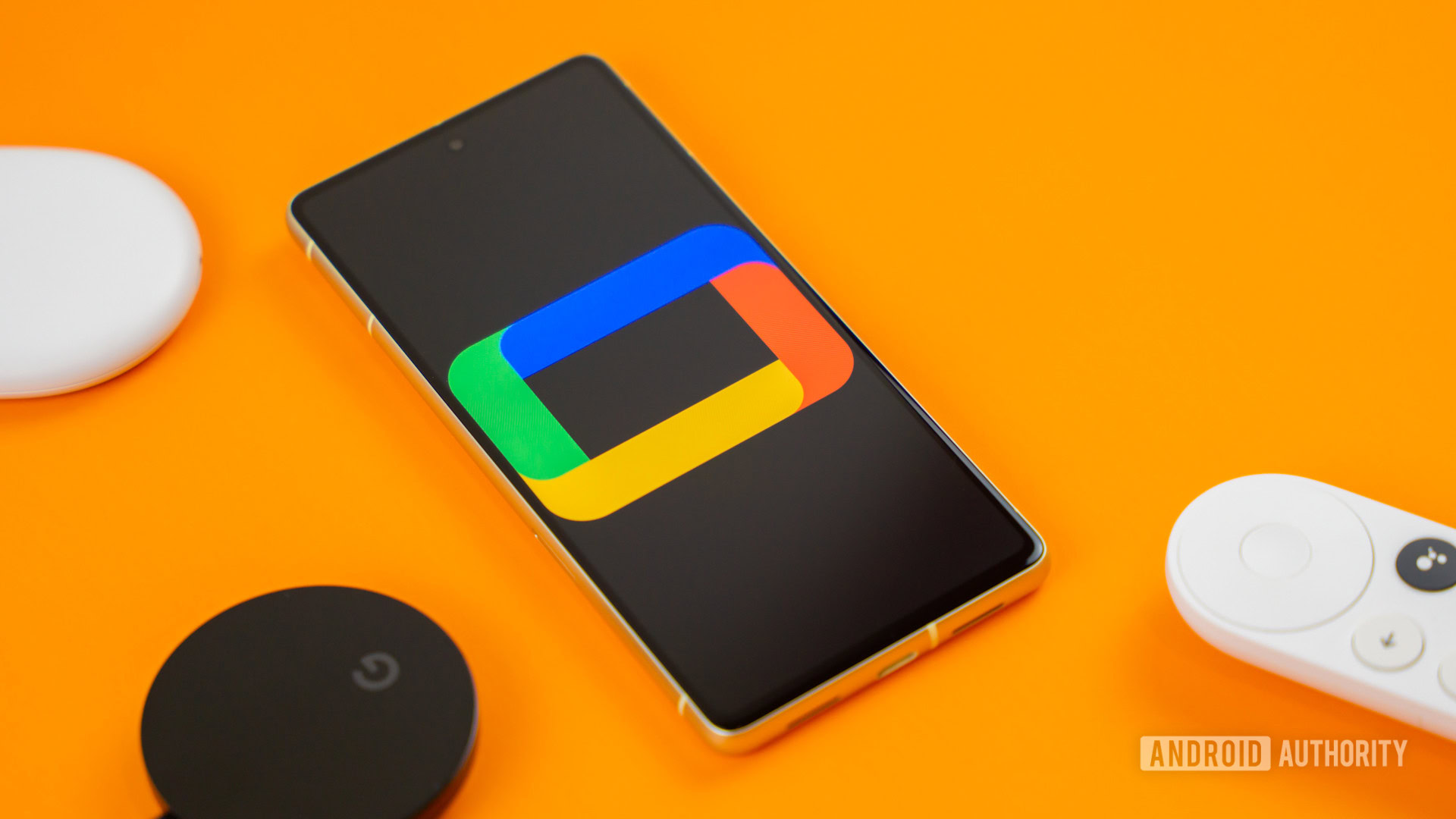 Google TV logo on smartphone next to Chromecast devices and remote Stock photo 5 Google TV logo on smartphone next to Chromecast devices and remote Stock photo 5