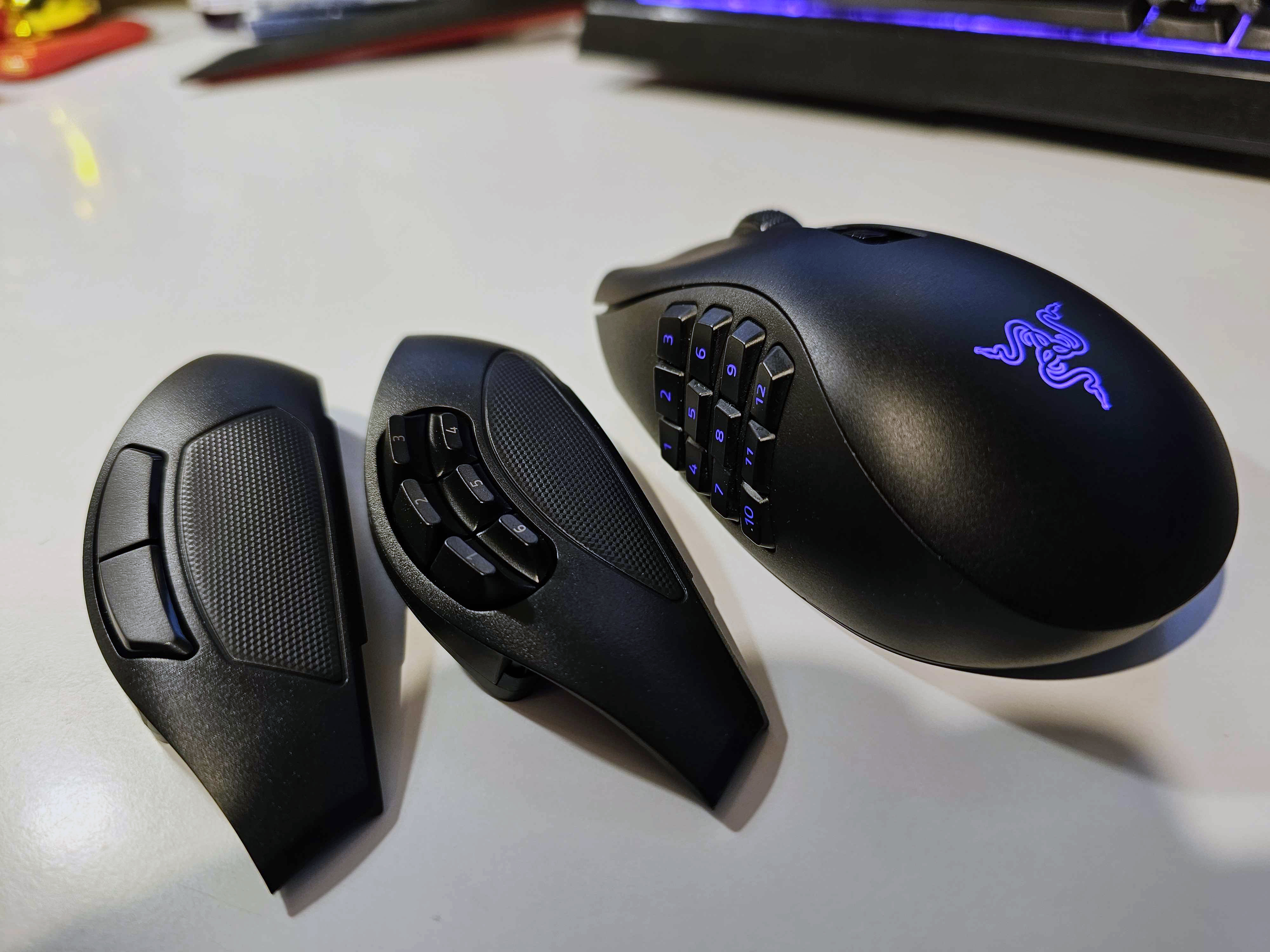 The Razer Naga V2 Pro gaming mouse on a white background, along with two swappable side plates.