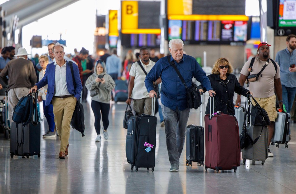 Passengers with luggage at Heathrow Airport during travel disruption.
