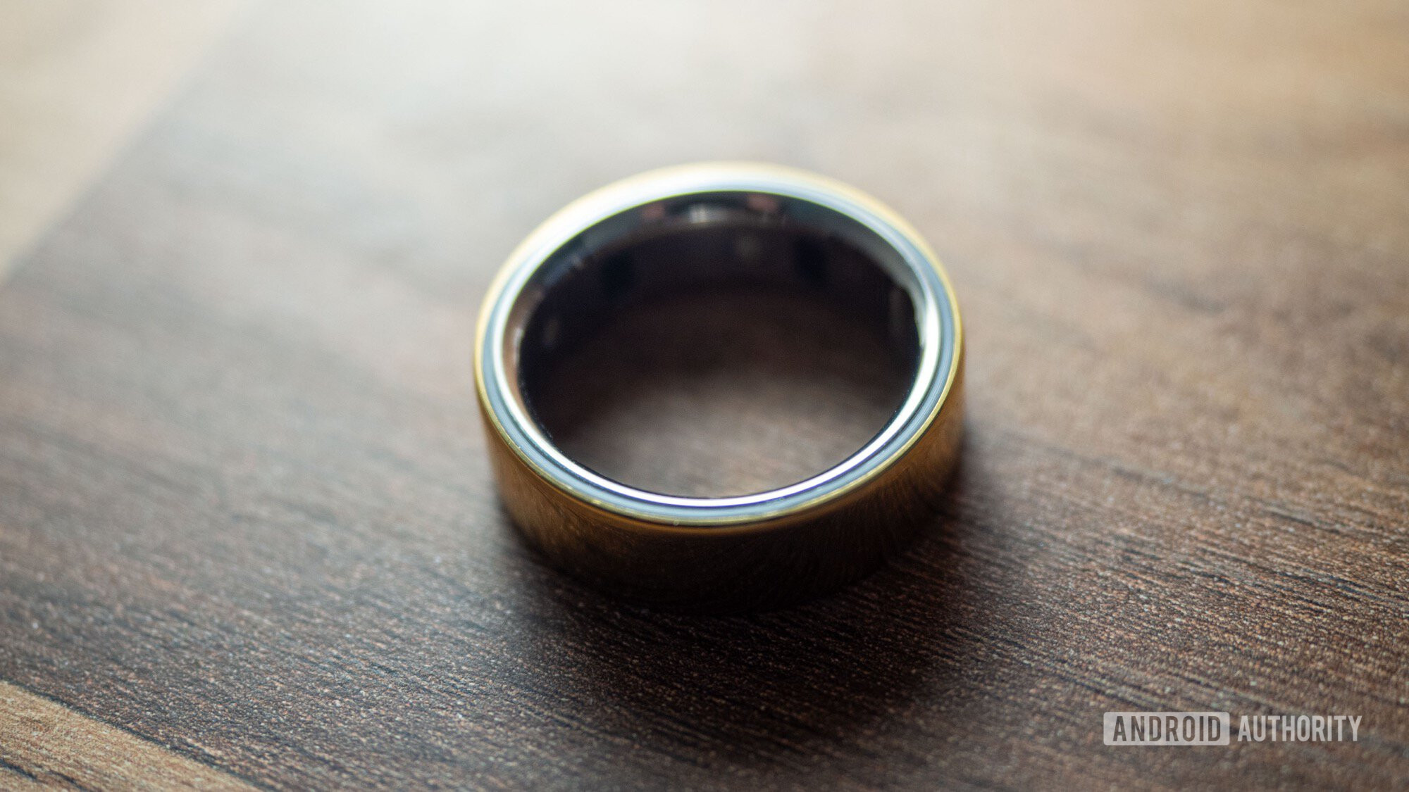 oura ring 4 3 An Oura Ring 4 rests on a wooden surface