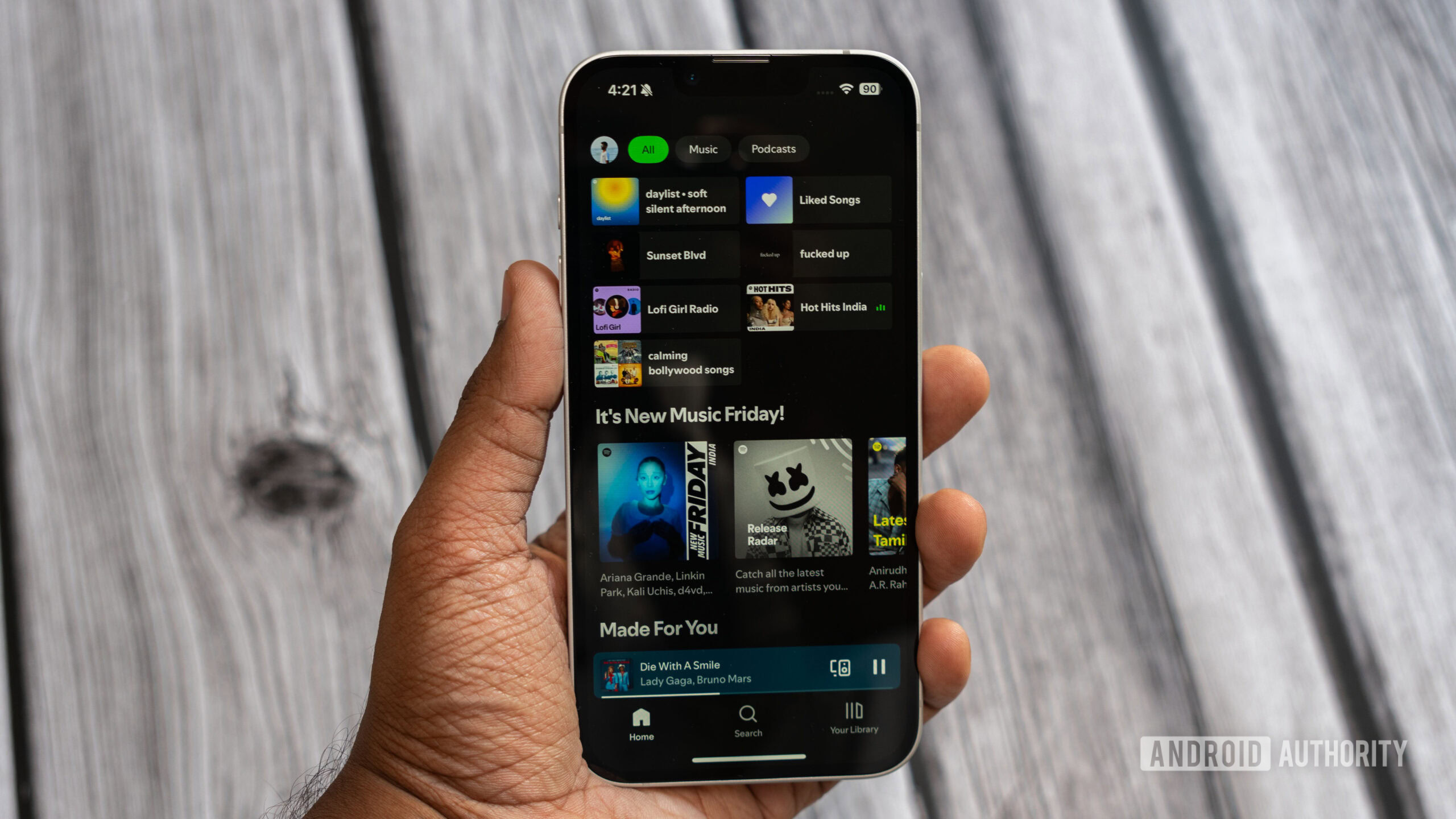 Apple iPhone 16e running Spotify