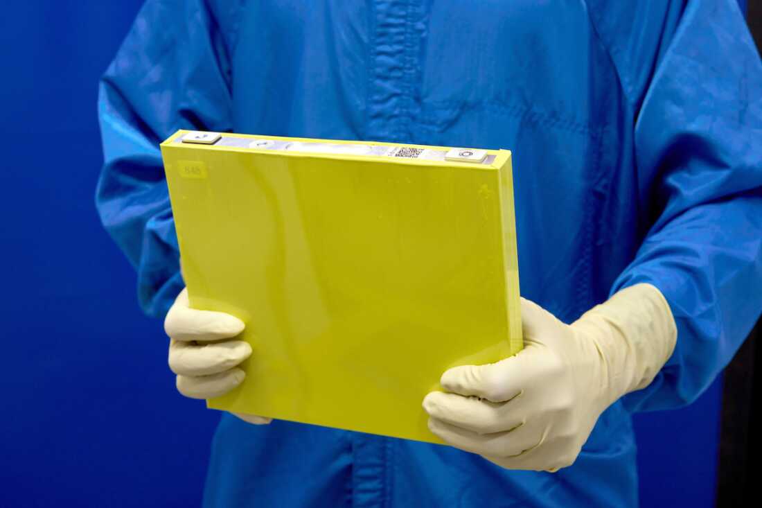An employee holds a full-size prototype LMR battery cell at the General Motors Wallace Battery Cell Innovation Center. GM has prototyped approximately 300 full-size LMR cells as it worked with LG Energy Solution to crack the code on the chemistry.