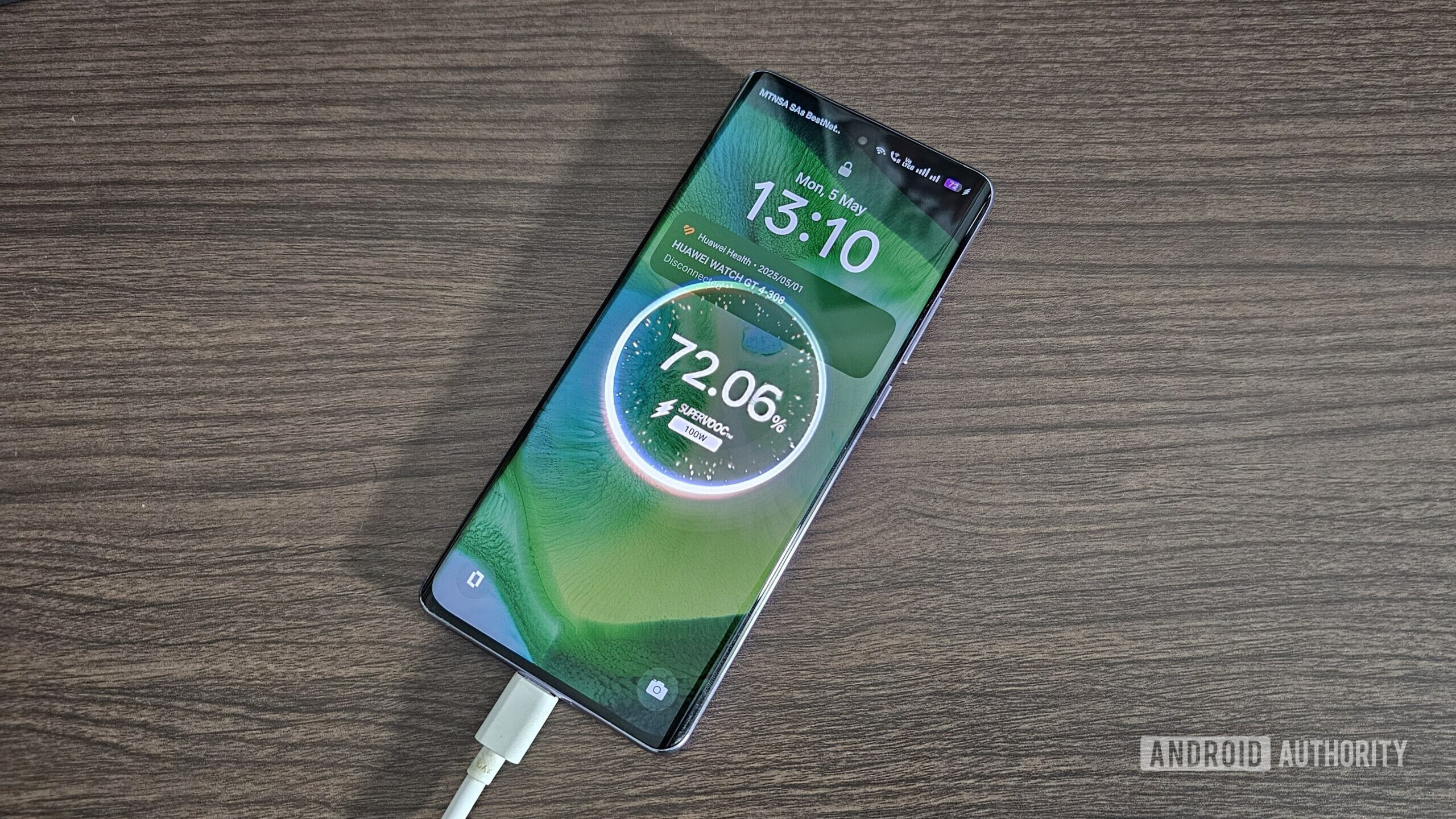 an oppo reno 10 pro+ smartphone on a table charging an oppo reno 10 pro+ smartphone on a table charging