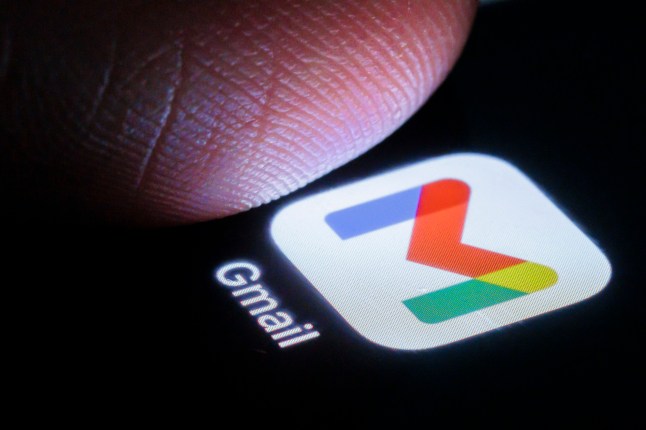Gmail app seen on a smartphone next to a finger